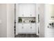 Hallway featuring white cabinetry with granite countertops and black hardware at 20866 W Werner Pl, Buckeye, AZ 85396