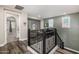 Stylish hallway with dark wood floors, wrought iron railing, and gray accent wall at 20866 W Werner Pl, Buckeye, AZ 85396