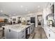 Open-concept kitchen featuring a large island with granite countertops and stainless steel appliances at 20866 W Werner Pl, Buckeye, AZ 85396