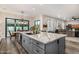 A spacious kitchen island features wood floors, granite countertops, and modern fixtures at 20866 W Werner Pl, Buckeye, AZ 85396
