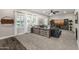 Bright living room showcasing a ceiling fan, modern console, and ample natural light at 20866 W Werner Pl, Buckeye, AZ 85396