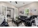 Cozy living room featuring comfortable seating, a ceiling fan, and natural light at 20866 W Werner Pl, Buckeye, AZ 85396