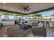 Luxurious outdoor living area with comfortable seating, a built-in bar, and a full kitchen at 20866 W Werner Pl, Buckeye, AZ 85396