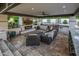 Luxurious outdoor living space with a built-in kitchen, fireplace, comfortable seating, and patio at 20866 W Werner Pl, Buckeye, AZ 85396