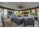 Spacious covered patio with comfortable seating, a fireplace, and modern ceiling fan at 20866 W Werner Pl, Buckeye, AZ 85396