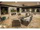 Inviting outdoor living area with a fireplace, TV, built-in grill, and comfortable seating at 20866 W Werner Pl, Buckeye, AZ 85396