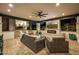 Relaxing outdoor living space with a fireplace, television, and comfortable woven seating at 20866 W Werner Pl, Buckeye, AZ 85396