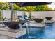 Close-up of a modern swimming pool with fire bowls and decorative water features at 20866 W Werner Pl, Buckeye, AZ 85396