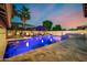 Beautiful backyard pool with in-pool seating, spa, umbrella seating, and fire bowls at 20866 W Werner Pl, Buckeye, AZ 85396