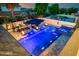Stunning aerial view of a backyard pool featuring an integrated spa and fire bowls at 20866 W Werner Pl, Buckeye, AZ 85396