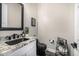 Modern powder room with granite countertop and black fixtures at 20866 W Werner Pl, Buckeye, AZ 85396
