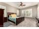 A serene bedroom features a dark wood bed frame, white shuttered windows and a calming color palette at 21353 S 185Th Way, Queen Creek, AZ 85142