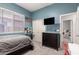 This stylish bedroom features blue walls, a closet, a dresser, and an American flag at 21353 S 185Th Way, Queen Creek, AZ 85142