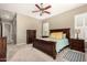 Well-lit bedroom features wood furniture, a ceiling fan, and neutral decor, with an adjacent closet at 21353 S 185Th Way, Queen Creek, AZ 85142