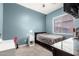 This cozy bedroom features light blue walls, carpet floors, and a sleek black bed frame at 21353 S 185Th Way, Queen Creek, AZ 85142