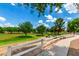 Beautiful community park with a white fence, lush greenery and sidewalk at 21353 S 185Th Way, Queen Creek, AZ 85142