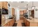 Bright kitchen with granite countertops, wood cabinets, black appliances, and plenty of counter space at 21353 S 185Th Way, Queen Creek, AZ 85142