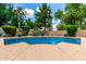 Sparkling blue pool is surrounded by a concrete patio and well-manicured landscaping at 21353 S 185Th Way, Queen Creek, AZ 85142