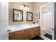 Bathroom features a dual sink vanity with a tile countertop, framed mirror and modern lighting at 2270 E Indian Wells Dr, Chandler, AZ 85249