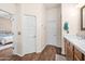 Bathroom features wood-look flooring, double vanity, and entry into a bedroom at 2270 E Indian Wells Dr, Chandler, AZ 85249