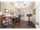 Bedroom featuring a ceiling fan, wood-look floors, and large sunny window at 2270 E Indian Wells Dr, Chandler, AZ 85249
