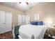 Bright bedroom showcases a decorative ceiling fan, spacious closet and dark-toned hardwood floors at 2270 E Indian Wells Dr, Chandler, AZ 85249
