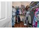 Walk-in closet with lots of clothes, shelving, and wood look floors at 2270 E Indian Wells Dr, Chandler, AZ 85249
