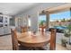 Dining area features a wooden table with seating, a bright window overlooking the pool, and access to the patio at 2270 E Indian Wells Dr, Chandler, AZ 85249