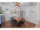 Dining room featuring wood floors, a ceiling fan, and a rustic table with seating for six at 2270 E Indian Wells Dr, Chandler, AZ 85249