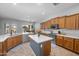 Bright kitchen featuring wood cabinetry, stainless steel appliances, a center island, and views of the backyard pool at 2270 E Indian Wells Dr, Chandler, AZ 85249