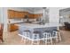 Open kitchen features a large center island, white countertops, modern appliances, and a view into the dining area at 2270 E Indian Wells Dr, Chandler, AZ 85249