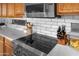 Close-up of modern kitchen appliances including a cooktop, microwave, and subway tile backsplash at 2270 E Indian Wells Dr, Chandler, AZ 85249