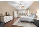 Cozy primary bedroom featuring a ceiling fan, a dresser, and natural light from shuttered windows at 2270 E Indian Wells Dr, Chandler, AZ 85249