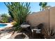A cozy patio with a table and chairs, surrounded by lush landscaping for tranquil outdoor seating at 2270 E Indian Wells Dr, Chandler, AZ 85249