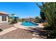 Backyard with a pool, desert landscaping, rock waterfall, and room for outdoor entertaining at 2270 E Indian Wells Dr, Chandler, AZ 85249