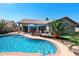 Backyard features a sparkling pool, palm trees and an outdoor seating area for relaxing at 2270 E Indian Wells Dr, Chandler, AZ 85249
