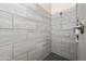 Close up of a gray tiled walk-in shower with brushed nickel fixtures and dark tile floor at 2270 E Indian Wells Dr, Chandler, AZ 85249