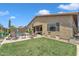 Beautiful backyard featuring a well-manicured lawn, patio furniture, and privacy fencing at 22927 E Via Del Oro --, Queen Creek, AZ 85142