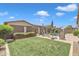 Lush backyard featuring a well-manicured lawn, patio furniture, privacy fencing, and green landscaping at 22927 E Via Del Oro --, Queen Creek, AZ 85142
