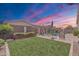 Lush backyard featuring a manicured lawn, mature trees, and privacy fence that is ideal for outdoor relaxation at 22927 E Via Del Oro --, Queen Creek, AZ 85142