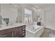 Bright bathroom with a soaking tub, a walk-in shower, and dual vanities at 22927 E Via Del Oro --, Queen Creek, AZ 85142
