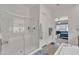 Bright bathroom featuring a glass shower, soaking tub, and access to the main bedroom at 22927 E Via Del Oro --, Queen Creek, AZ 85142