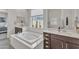 Bright bathroom with a soaking tub, a walk-in shower, and dual vanities at 22927 E Via Del Oro --, Queen Creek, AZ 85142