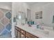 Bathroom featuring double sinks, mirror, shower, and gray flooring at 22927 E Via Del Oro --, Queen Creek, AZ 85142