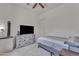 Neutral bedroom with a large TV on a dresser, and a cozy bed at 22927 E Via Del Oro --, Queen Creek, AZ 85142