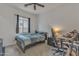 Bedroom with fan, window, bed, desk, chair, and guitar at 22927 E Via Del Oro --, Queen Creek, AZ 85142