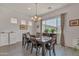 Bright dining room with a wooden table, decorative chandelier, and natural light from the window at 22927 E Via Del Oro --, Queen Creek, AZ 85142