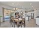 Open-concept dining room and kitchen with stainless steel appliances and access to an outdoor patio at 22927 E Via Del Oro --, Queen Creek, AZ 85142