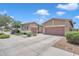 Spacious two-car garage, well-manicured lawn, and mature trees enhance curb appeal at 22927 E Via Del Oro --, Queen Creek, AZ 85142