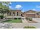 Inviting home exterior featuring manicured lawn, mature trees, and two-car garage at 22927 E Via Del Oro --, Queen Creek, AZ 85142